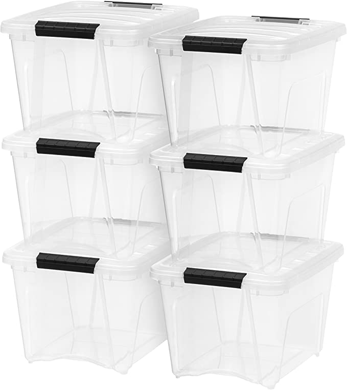 clear storage bins with black handles that stack for storing materials for science lessons. 
